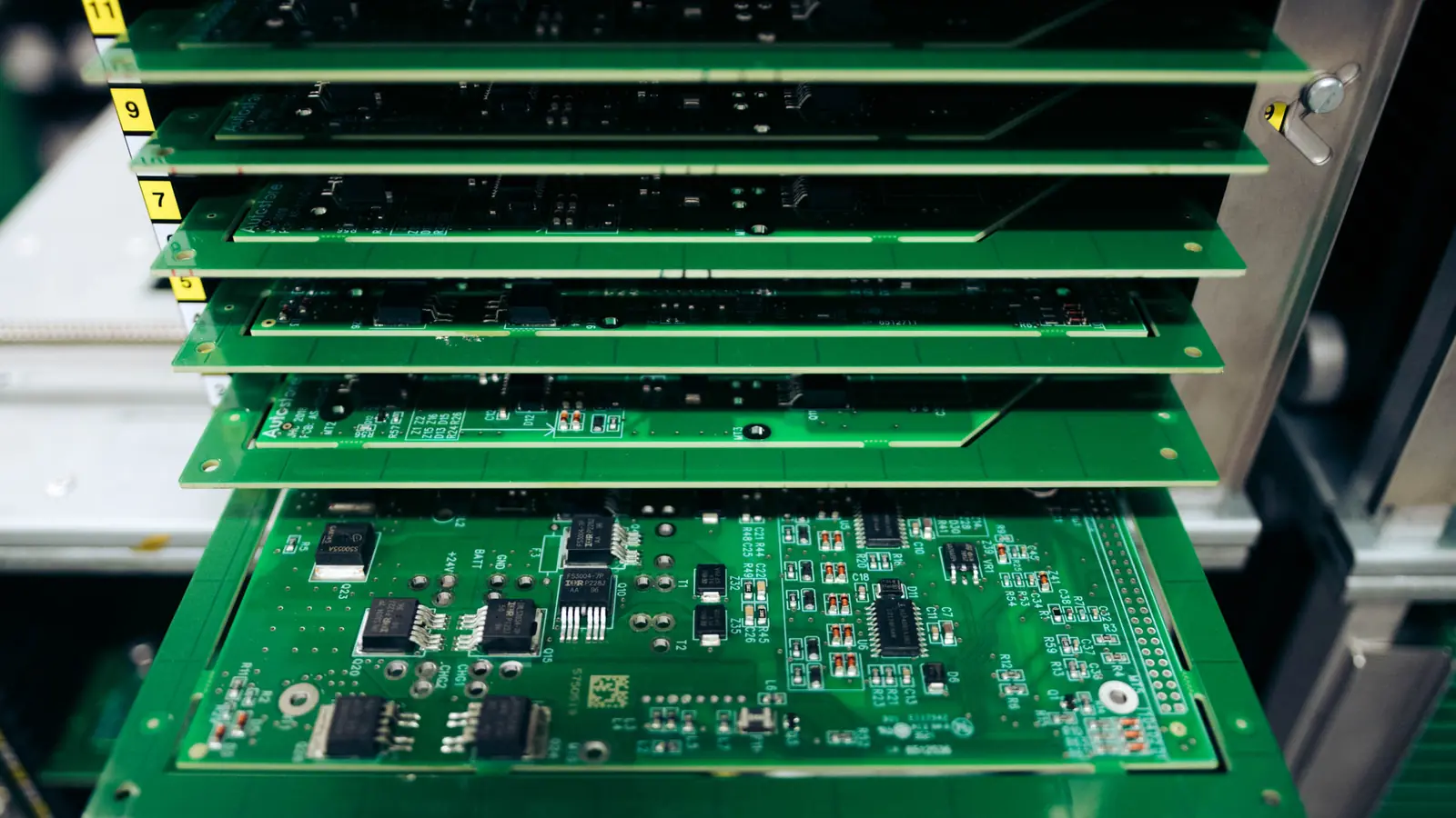 A stack of populated circuit boards in a magazine