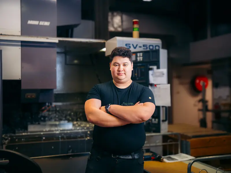 Young employee at a CNC machining centre