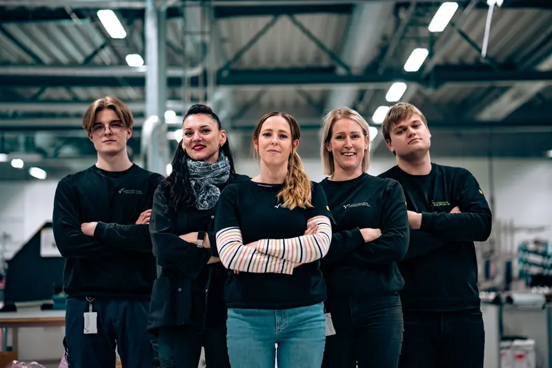 Five Westcontrol employees standing together in the factory
